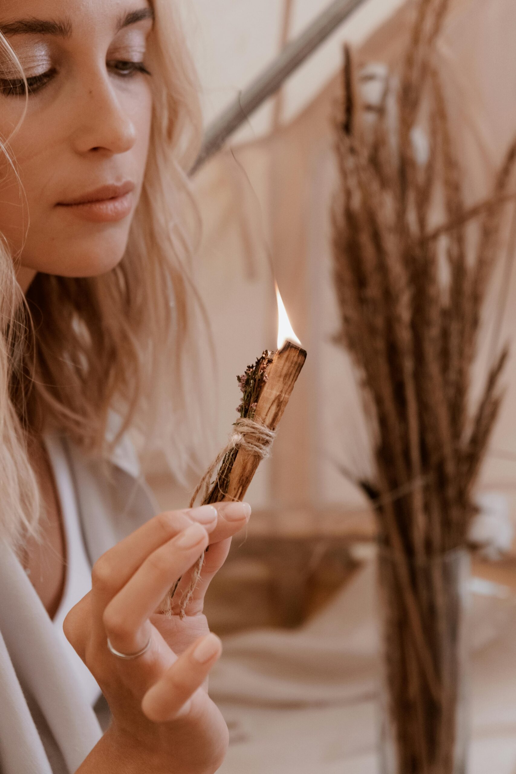 Woman with lit palo santo stick